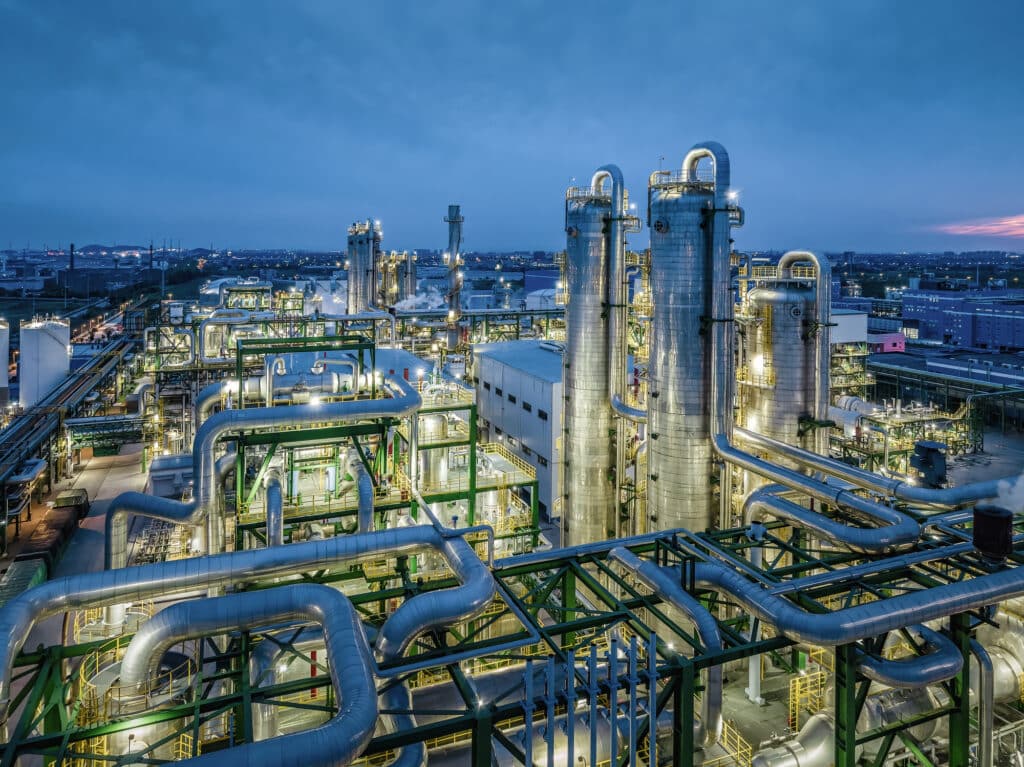 Artificial lights illuminating the structure of a chemical processing plant at night